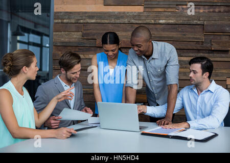 Business executives discussing during meeting in office Stock Photo