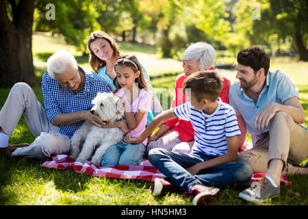 Happy family enjoying in park on sunny a day Stock Photo