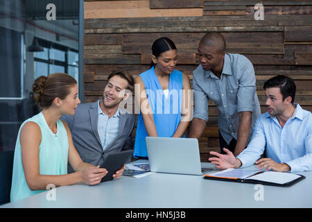 Business executives discussing during meeting in office Stock Photo