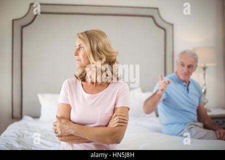 Couple having an argument in bedroom at home Stock Photo