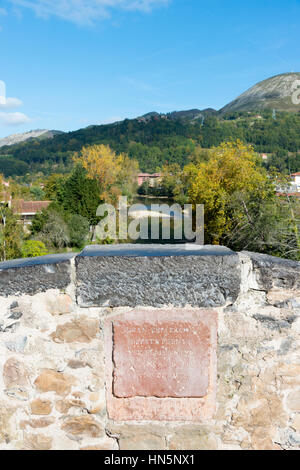 A detail and carved stone laque on the Roman Bridge of Cangas de On’s an ancient stone bridge over the river Sella in the Picos de Europa Spain Stock Photo