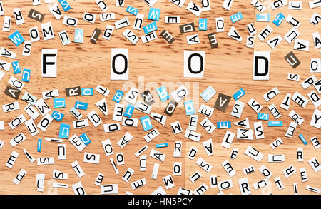 Food word from cut out letters on wooden table Stock Photo