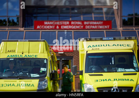 liveried ambulances parked on duty in designated bays at Manchester Royal Infirmary  accident and emergency department Stock Photo