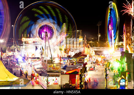 Fairground carnival rides at night time Stock Photo