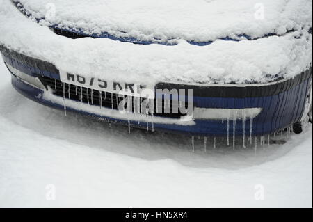 Car covered with snow and Icicles Stock Photo