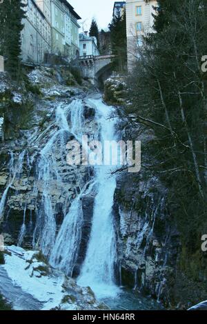 A waterfall is plunging through the town Bad Gastein, a famous health resort and also ski resort. Austria, Province of Salzburg, Europe. Stock Photo