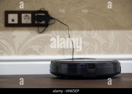 robot vacuum cleaner in the interior of the apartment Stock Photo