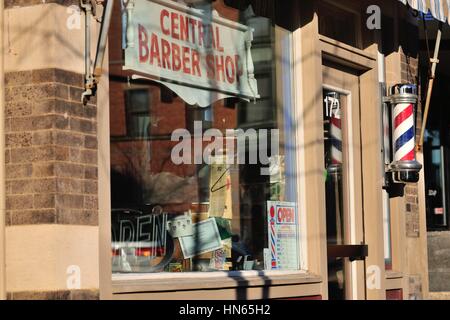 A link to another era, a barber pole fronting an old-fashioned barber shop in Elgin, Illinois, USA. Stock Photo