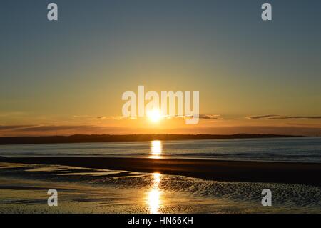 Sunset over Anglesey from Llanfairfechan Stock Photo