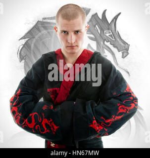 Man dressed in black dragon kimono demonstrating martial arts co Stock Photo