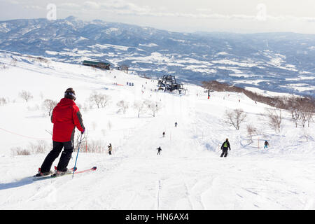 Niseko, Japan - March 4, 2012: Wide view showing skiers, slopes and lifts on Mount Annupuri in the ski resort of Niseko on Hokkaido island, Northern J Stock Photo