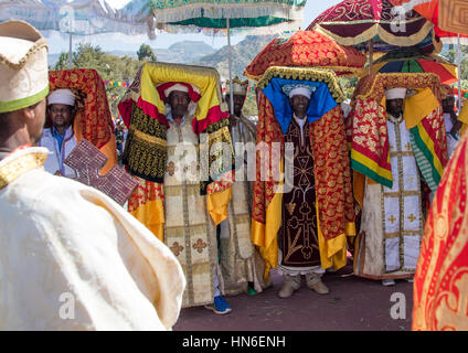 Ethiopian priests carrying some covered tabots on their heads during Timkat epiphany festival, Amhara region, Lalibela, Ethiopia Stock Photo