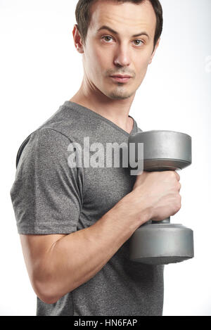 Handsome man training in clean modern gym on various machines Stock ...