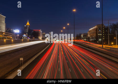 Atlanta, Georgia, USA - February 15, 2014:  Night freeway traffic in midtown Atlanta speeding towards downtown towers. Stock Photo