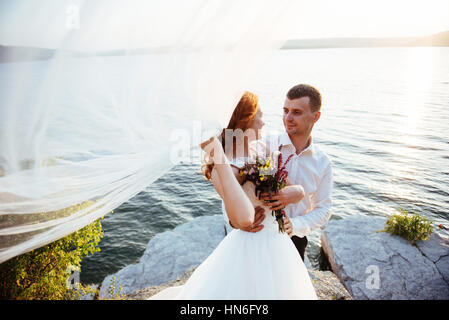 beautiful lovely blonde bride and groom classy on the rocks, ami Stock Photo