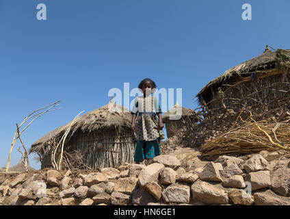 Little girl in front of a traditional wood house, Amhara region, Weldiya, Ethiopia Stock Photo