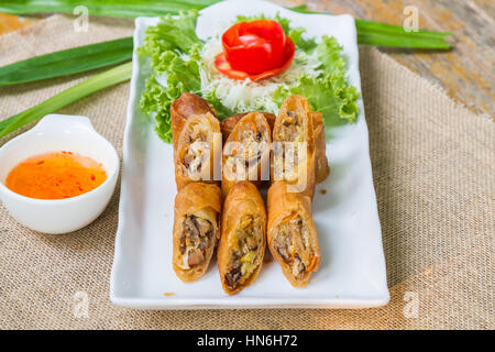 Deep fried spring rolls and sweet sauce on white plate. Stock Photo