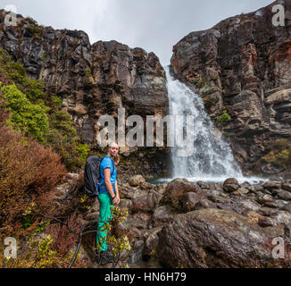 Hiker the Taranaki Falls, waterfall, Tongariro National Park, North Island, New Zealand Stock Photo