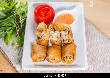 Deep fried spring rolls and sweet sauce on white plate. Stock Photo