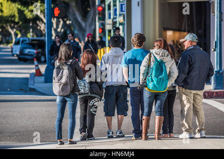 Los Angeles, USA - December 25, 2015: Pedestrians crossing the famous Santa Monica boulevard during winter bundled up with coats Stock Photo
