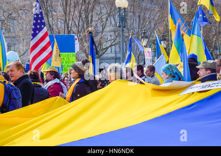 Washington DC, USA - March 6, 2014: People holding large Ukrainian flag during protest by White House Stock Photo