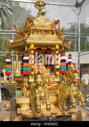 Golden chariot of Lord Murugan during Thaipusam celebration in Penang. Devotees performing kavadi attam towards Lord Murugan, God of War in Hinduism. Stock Photo