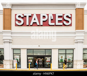 Fairfax, USA - November 25, 2016: Staples store facade with large sign and person walking by entrance Stock Photo