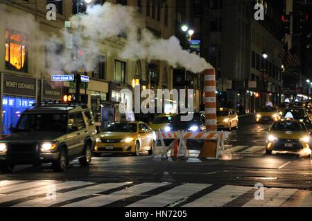 Steam vapor vented through a typical Con Edison orange and white steam stack in Manhattan, New York City, USA Stock Photo