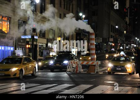 Steam vapor vented through a typical Con Edison orange and white steam stack in Manhattan, New York City, USA Stock Photo