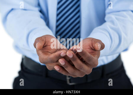 Mid section of mans hands cupped against white background Stock Photo