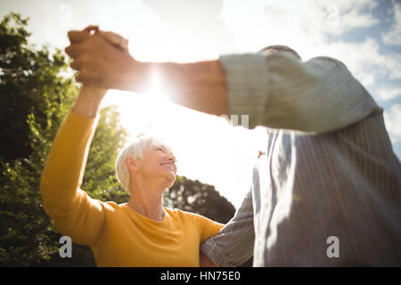 Happy senior couple dancing in park Stock Photo