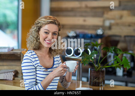 Portrait of smiling woman having coffee in cafÃƒÂ© Stock Photo