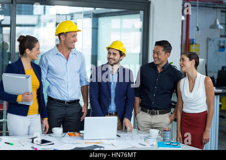 Business executives discussing during meeting in office Stock Photo