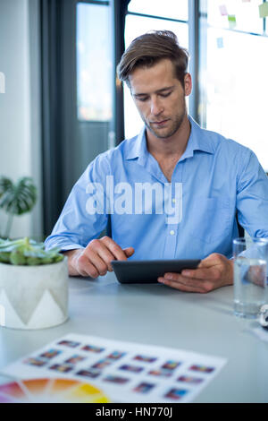 Male graphic designer using digital tablet in office Stock Photo