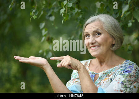 Older woman pointing Stock Photo