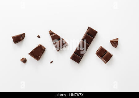 Chunks of Dark Chocolate On White Background. Stock Photo