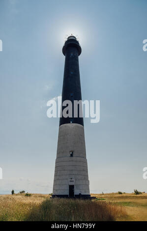 Sorve lighthouse against sun, Saaremaa island, Estonia Stock Photo