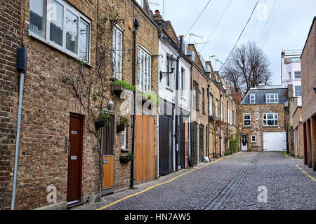 LONDON CITY - DECEMBER 25, 2016: Low apartment buildings of bricks in the alley Dunworth Mews leading from Portobello Road in Notting Hill Stock Photo