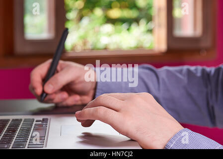 man creating sketch via lapton and tablet Stock Photo