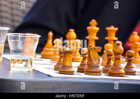 Wooden chess pieces at an outdoor restaurant table, Toulouse, Haute-Garonne, Occitanie, France Stock Photo