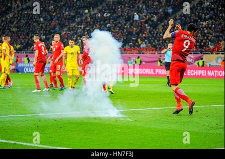 November 12, 2016: An exploding petard next to Robert Lewandowski #9 of Poland National Team during the  World Cup qualifying campaign 2018 game between Romania and Poland at National Arena Stadium, Bucharest,  Romania ROU. Foto: Cristian Stavri/ SportAction.ro |Copyright: CronosFoto/Cristian Stavri| Stock Photo