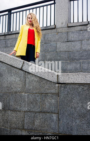 The young and beautiful girl student. Walking in the city of Vinnitsa Roshen embankment in spring day. Stock Photo