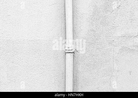 White wall with a pipe, detail of a textured wall Stock Photo