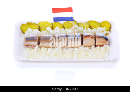 Dutch herring with gherkins and onions isolated on white. A traditional Dutch delicacy, with peak season at the end of spring when the first young her Stock Photo