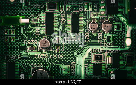 Detail of an electronic printed circuit board with many electrical components Stock Photo