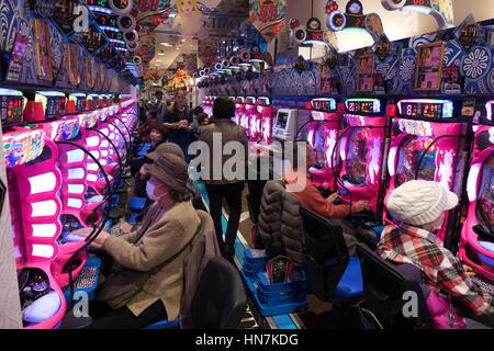 Japanese people playing pachinko, lottery, arcade game, videogame, video games, gambling, slot machines in Asian casino. Kyoto, Japan, Asia Stock Photo