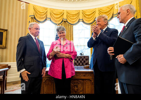 Washington, DC, USA. 09th Feb, 2017. Attorney General Jeff Sessions (L) smiles while Sessions' wife, Mary Blackshear Sessions (C-L), U.S. President Donald J. Trump (C-R), and Vice President Mike Pence (R) clap after he was sworn-in as attorney general in the Oval Office of the White House in Washington, DC, USA, 09 February 2017. On 08 February, after a contentious battle on party lines, the Senate voted to confirm Sessions as attorney general. Credit: Jim LoScalzo/Pool via CNP - NO WIRE SERVICE - Photo: Jim LoScalzo/Consolidated/dpa/Alamy Live News Stock Photo