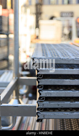 scaffolding disassembled and stacked after use at the construction site Stock Photo