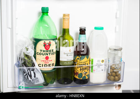 Contents of a fridge including a bottle of wine , beer and cider Stock Photo