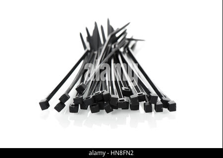 heap of black cable ties on white background Stock Photo